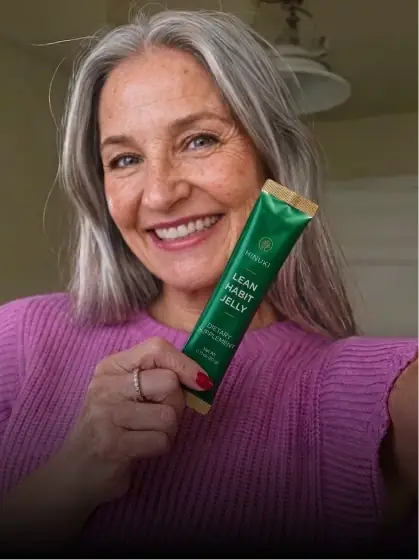 Woman holding Hinuki Lean Habit Jelly indoors