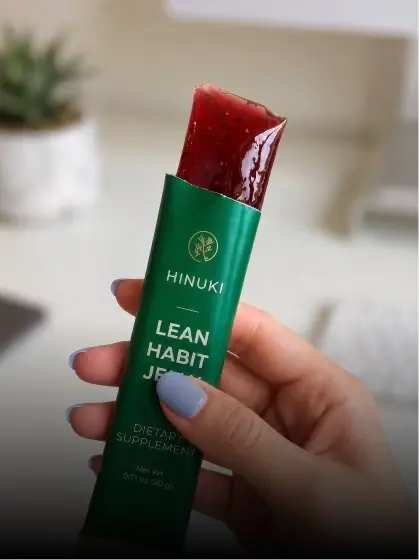 Hand holding Hinuki Lean Habit Jelly stick indoors